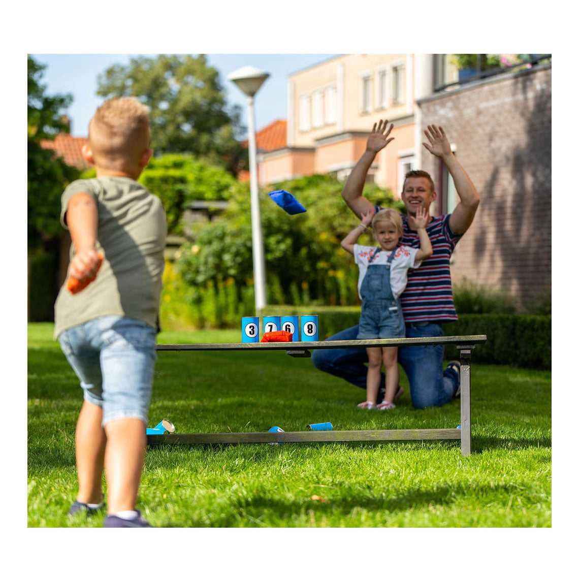 Outdoor play throwing cans